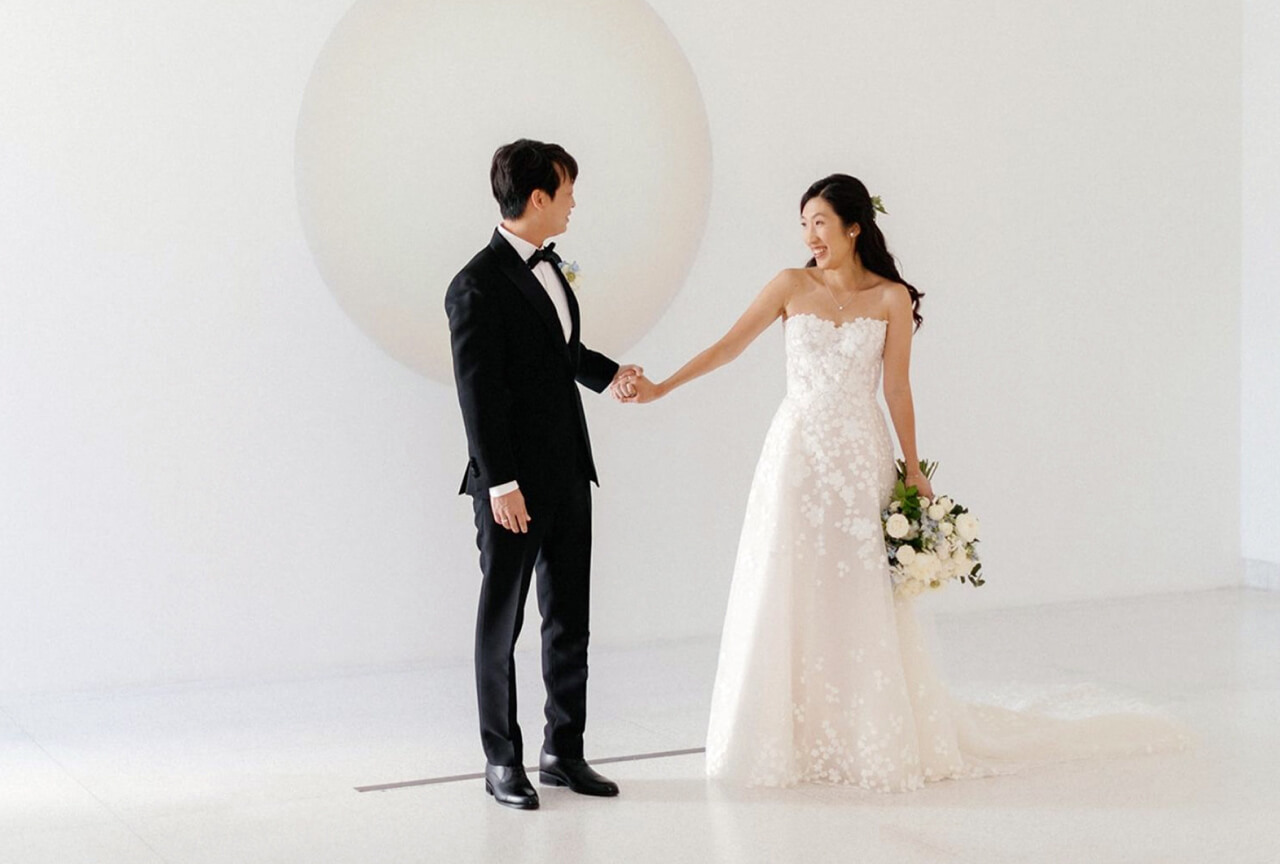 Bride and groom holding hands at a wedding reception